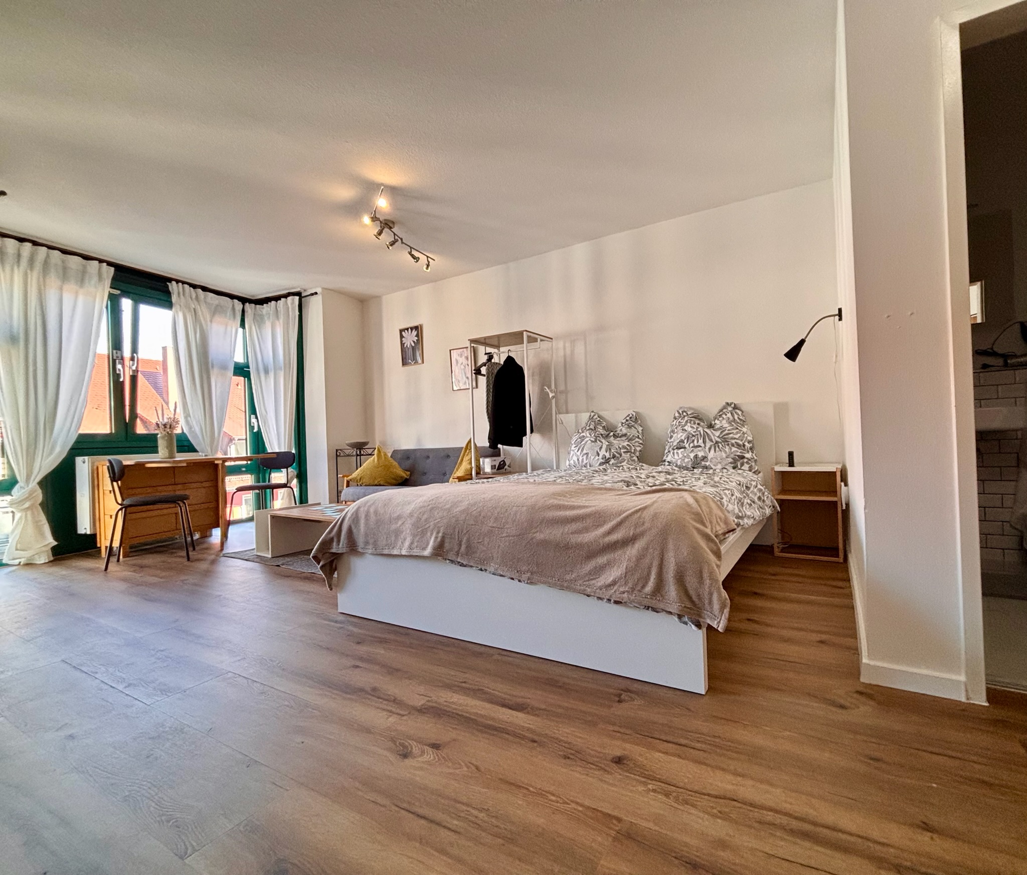 Grand Studio bed with patterned pillows and fresh linens